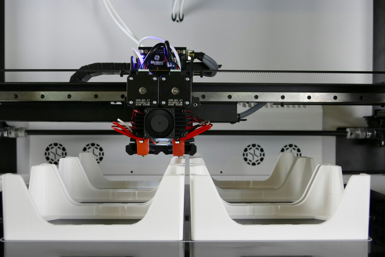 a 3D printer is seen creating three dimensional small parts production